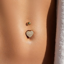 CZ belly button ring worn on model with gold heart design, fashionable body piercing jewelry