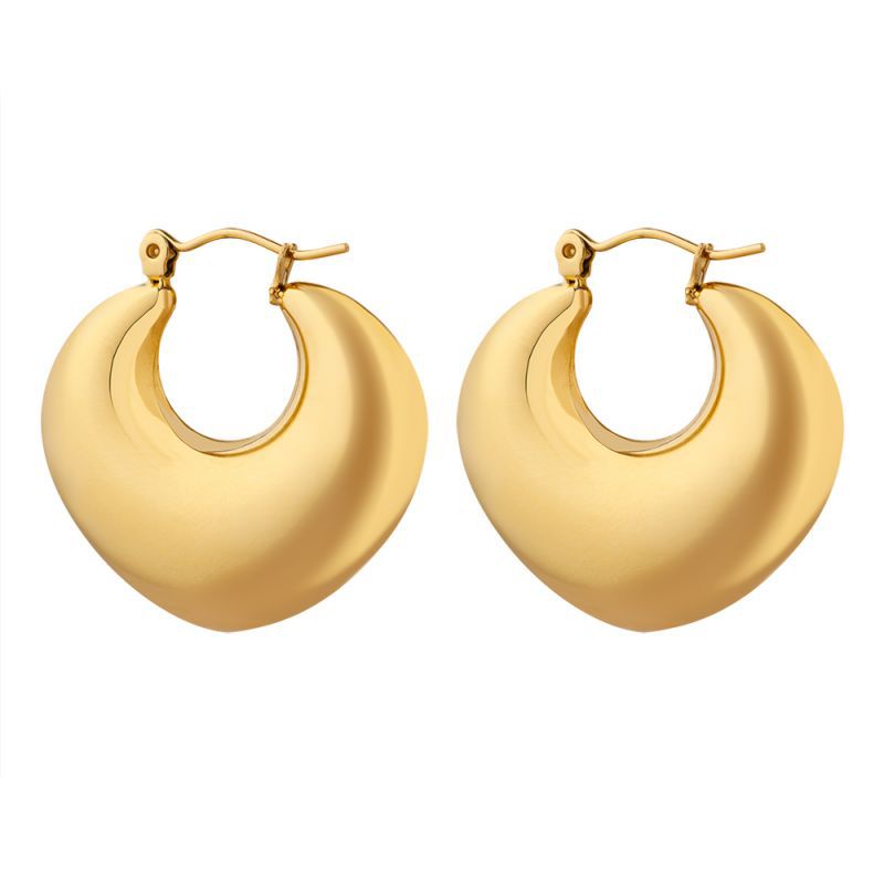 Flat lay of gold heart huggie hoop earrings in 316L stainless steel