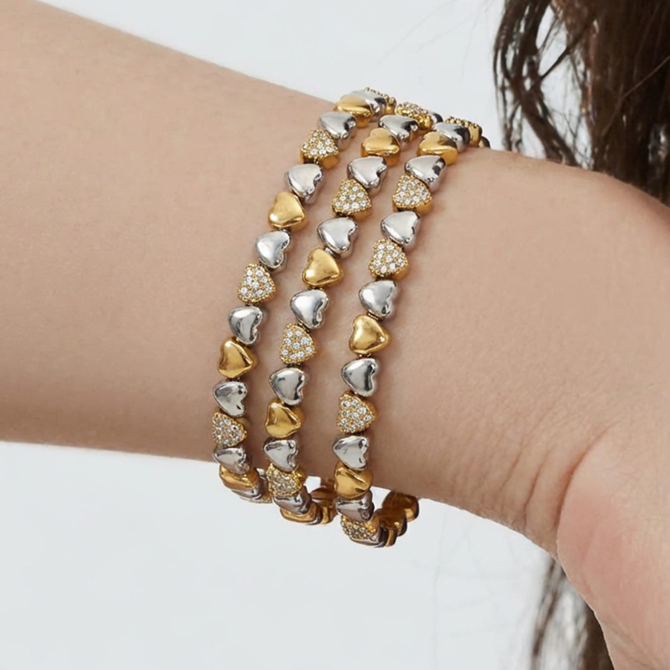 Close-up of 316L stainless steel heart zircon bracelet with two-tone PVD gold design.
