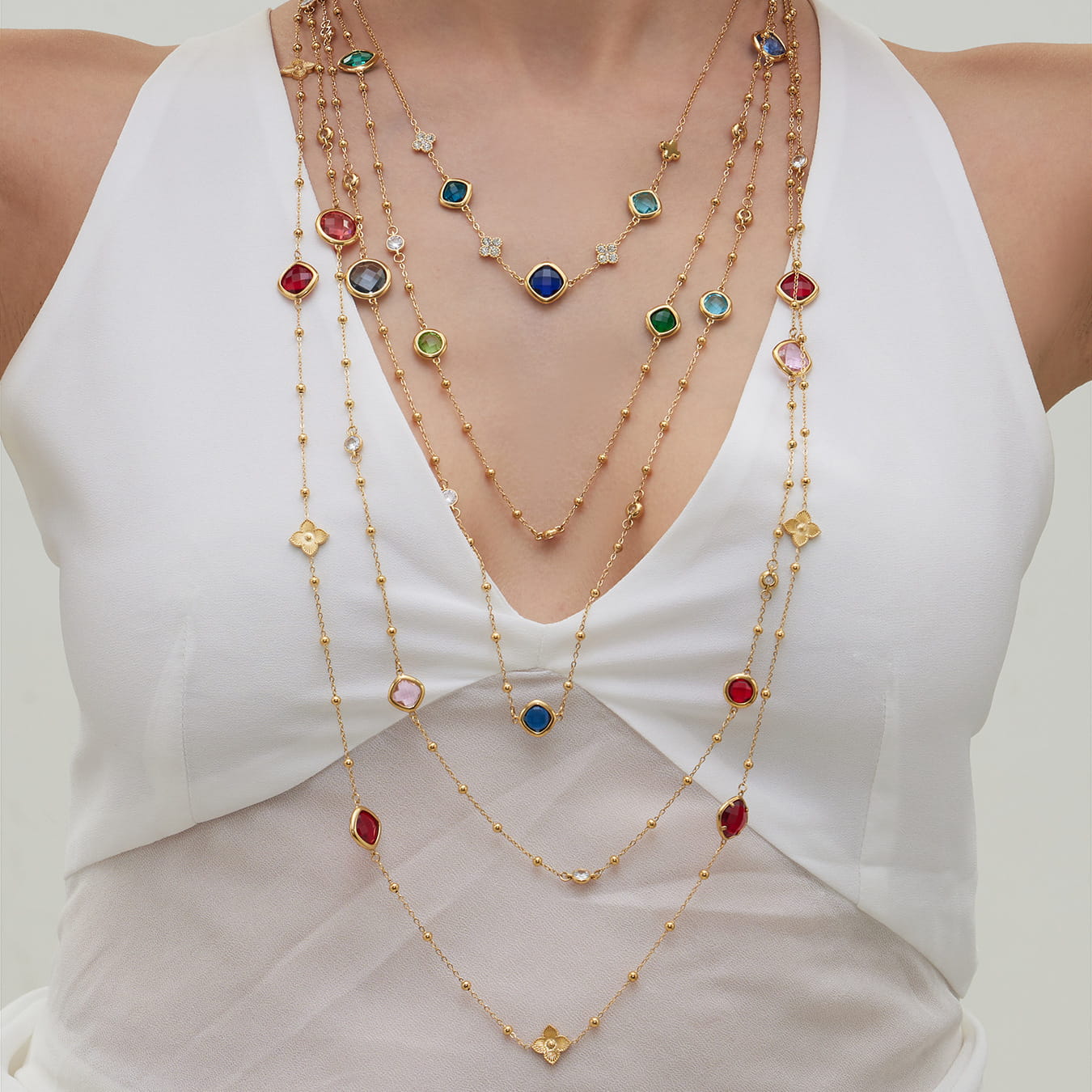 Model wearing layered 316L stainless steel glass stone necklaces
