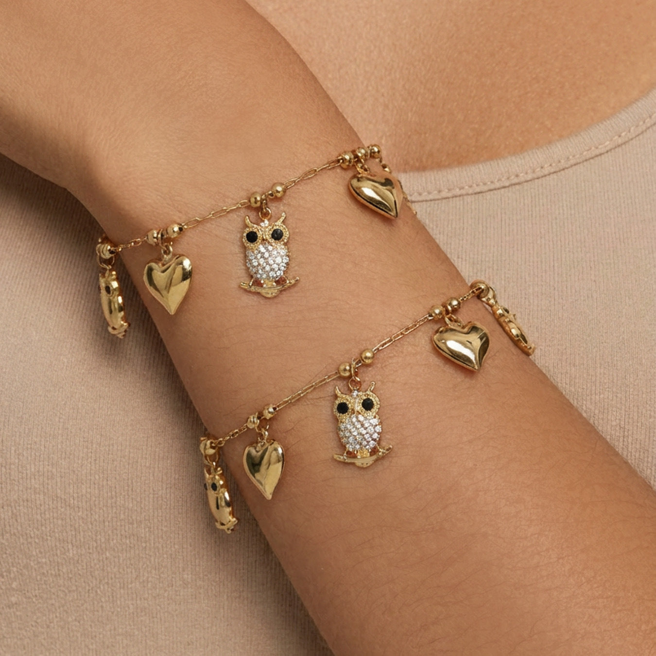 Model wearing 316L stainless steel owl charm bracelet with heart details