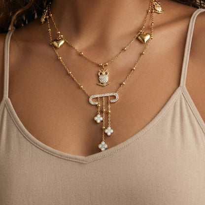 Model wearing 316L stainless steel owl charm necklace with zircon accents