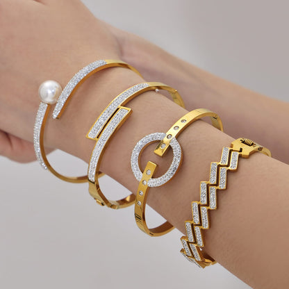 Hand shot of 316L stainless steel CZ geometric bangle bracelet set in 18K PVD gold, wholesale