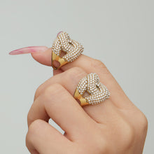 Gold tone 316L stainless steel pavé zircon open ring A387 on hand close up for boutique collections
