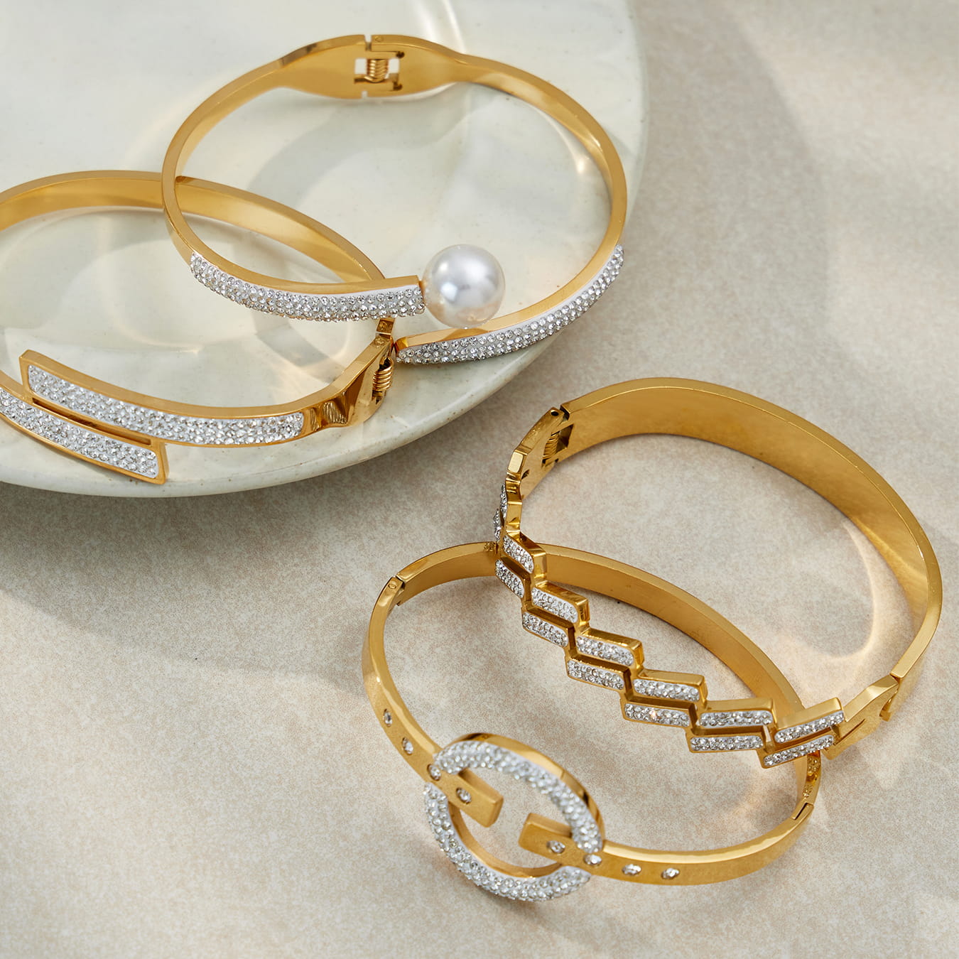 Close-up of 316L stainless steel hinged bangle with pavé CZ, 18K PVD gold plating