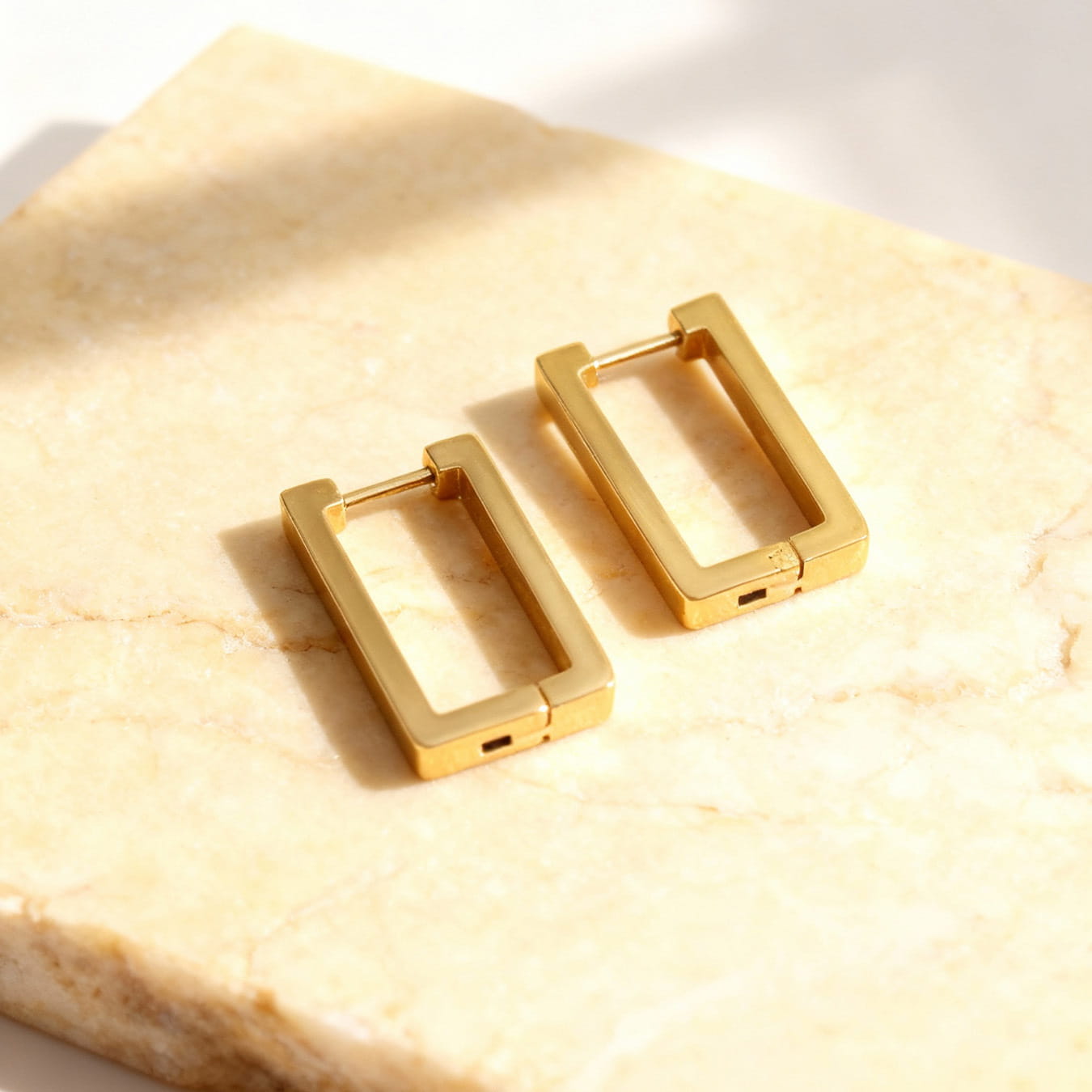 316L stainless steel rectangular huggie hoop earrings flat lay showing clean geometric shape