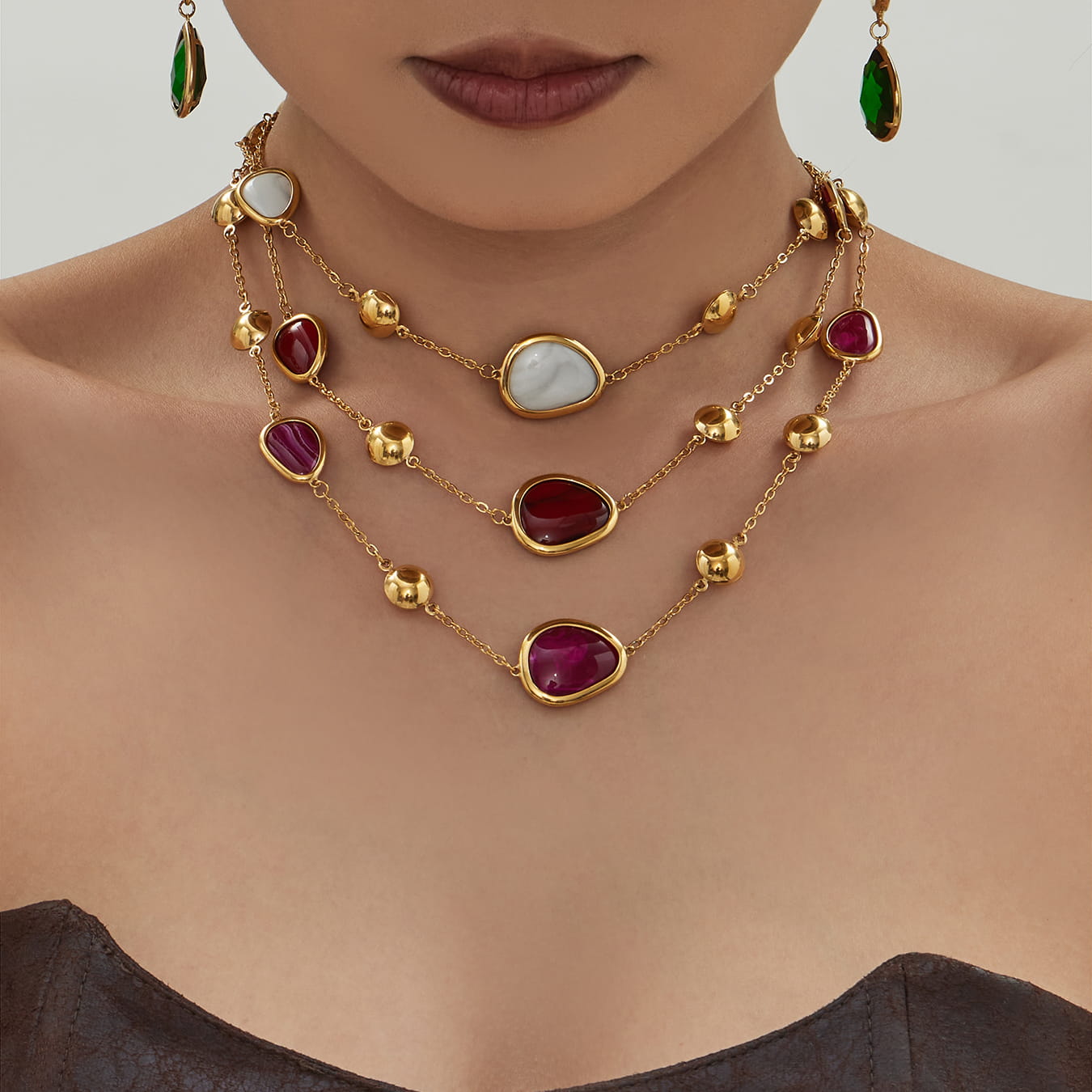 Gold tone 316L stainless steel resin stone layered necklace worn by model for boutique collections