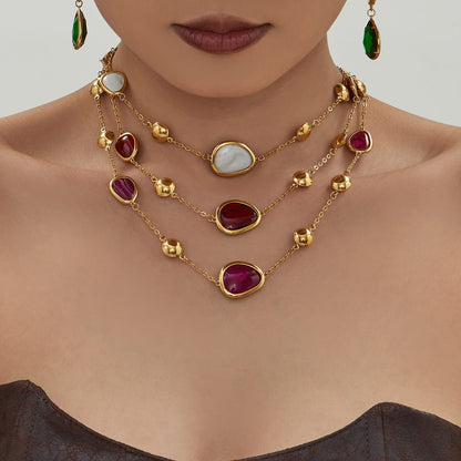 Gold tone 316L stainless steel resin stone layered necklace worn by model for boutique collections