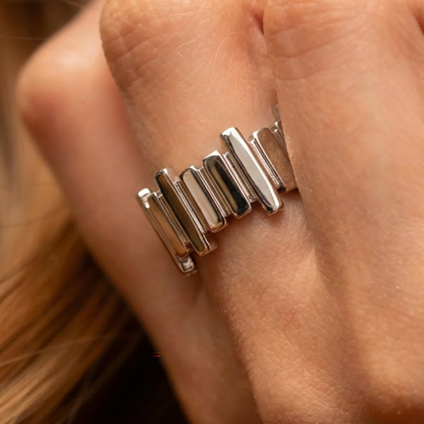 Silver tone ribbed open ring on hand, geometric stainless steel statement ring