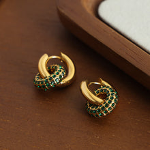 Close-up of zircon inlays on stainless steel earrings