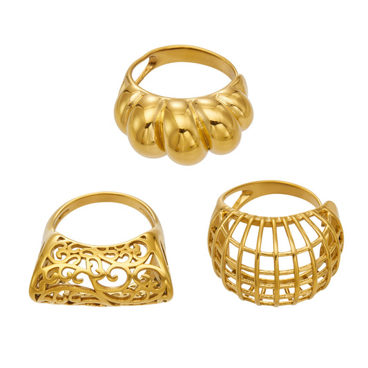 Gold tone 316L stainless steel statement rings in sculptural hollow and geometric cage designs