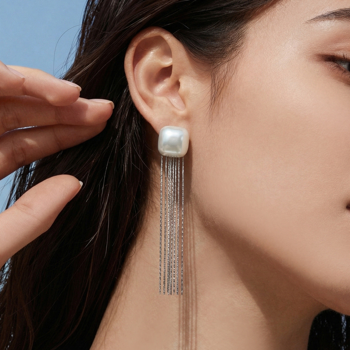 Model wearing 18K PVD gold 316L stainless steel shell bead tassel drop earrings