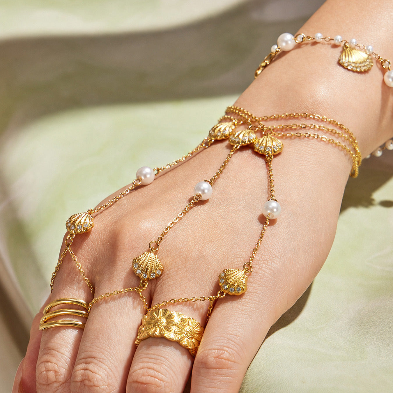 Shell zircon hand chain bracelet product detail in gold finish