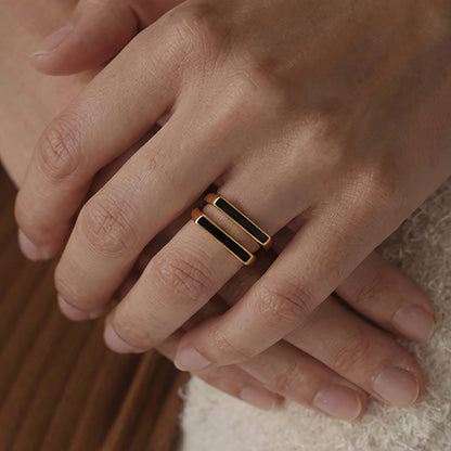 Stacking look with square black inlay rings, modern unisex minimalist style