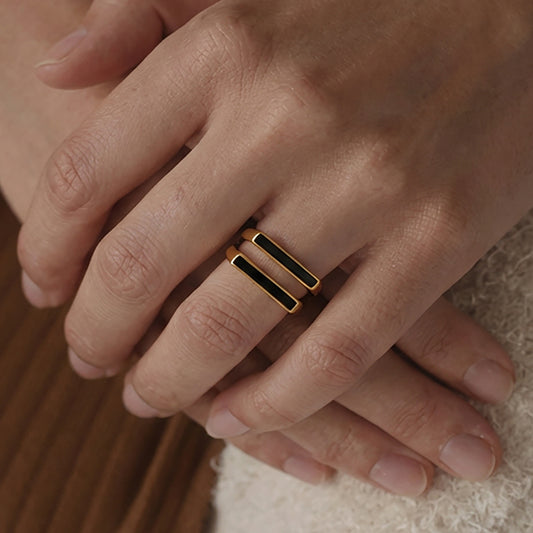 Stacking look with square black inlay rings, modern unisex minimalist style