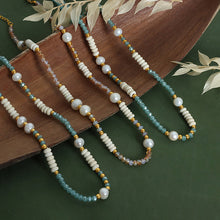 Lifestyle scene showing 316L stainless steel pearl and glass stone necklace for boutique brands