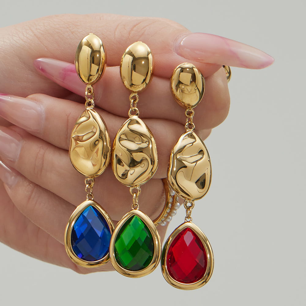 Flat lay of 316L stainless steel teardrop earrings with faceted Czech glass stones