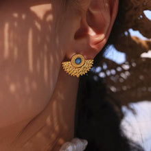 Gold turquoise statement stud earrings close-up on model