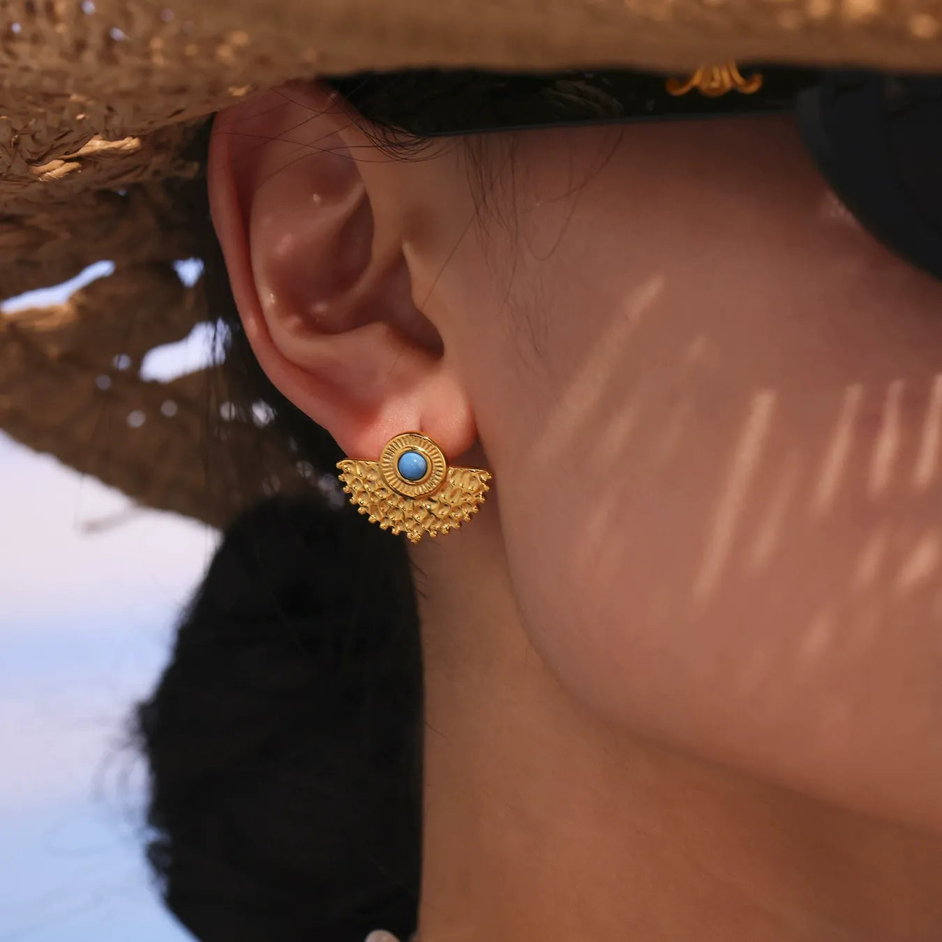 Turquoise peacock fan stud earrings modeled for boutique jewelry wholesale