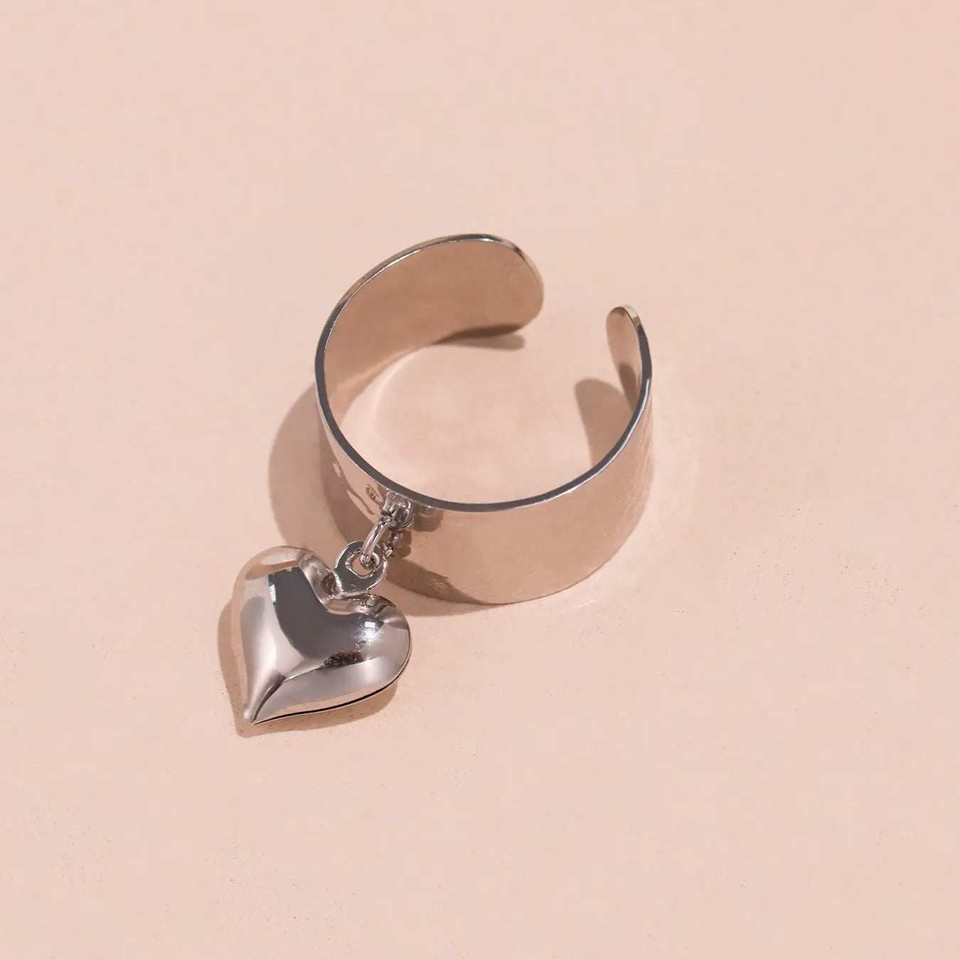 The silver-tone 316L stainless steel hypoallergenic wide band open heart ring designed for sensitive skin.