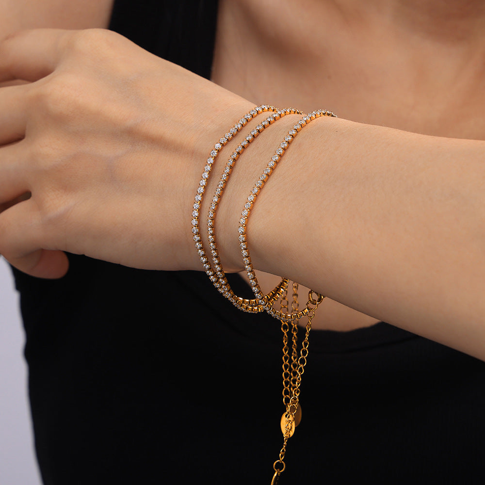 316L Stainless Steel zircon pave bracelet stacked with other waterproof jewelry, 18K gold PVD plating, tarnish-resistant