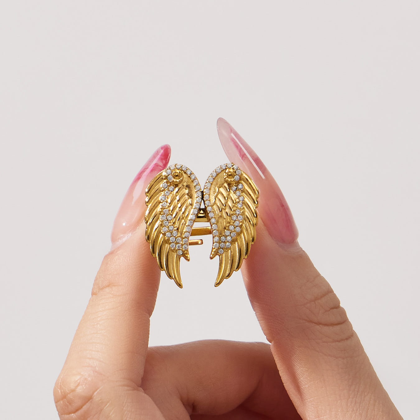 Close-up of zircon wing ring made of 316L stainless steel with gold pvd plating