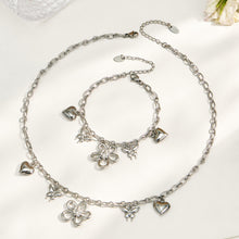 316L stainless steel butterfly charm necklace and matching floral bracelet in a polished steel finish
