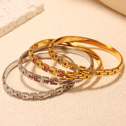18k gold plated & stainless steel 5a zircon clasp bangle set, displayed on textured surface