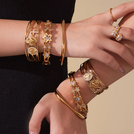 Woman wearing 18K gold plated 5A zircon star hollow out bangle set on wrist