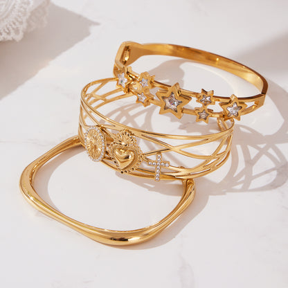 18K gold plated 5A zircon star hollow out bangle set displayed on marble surface