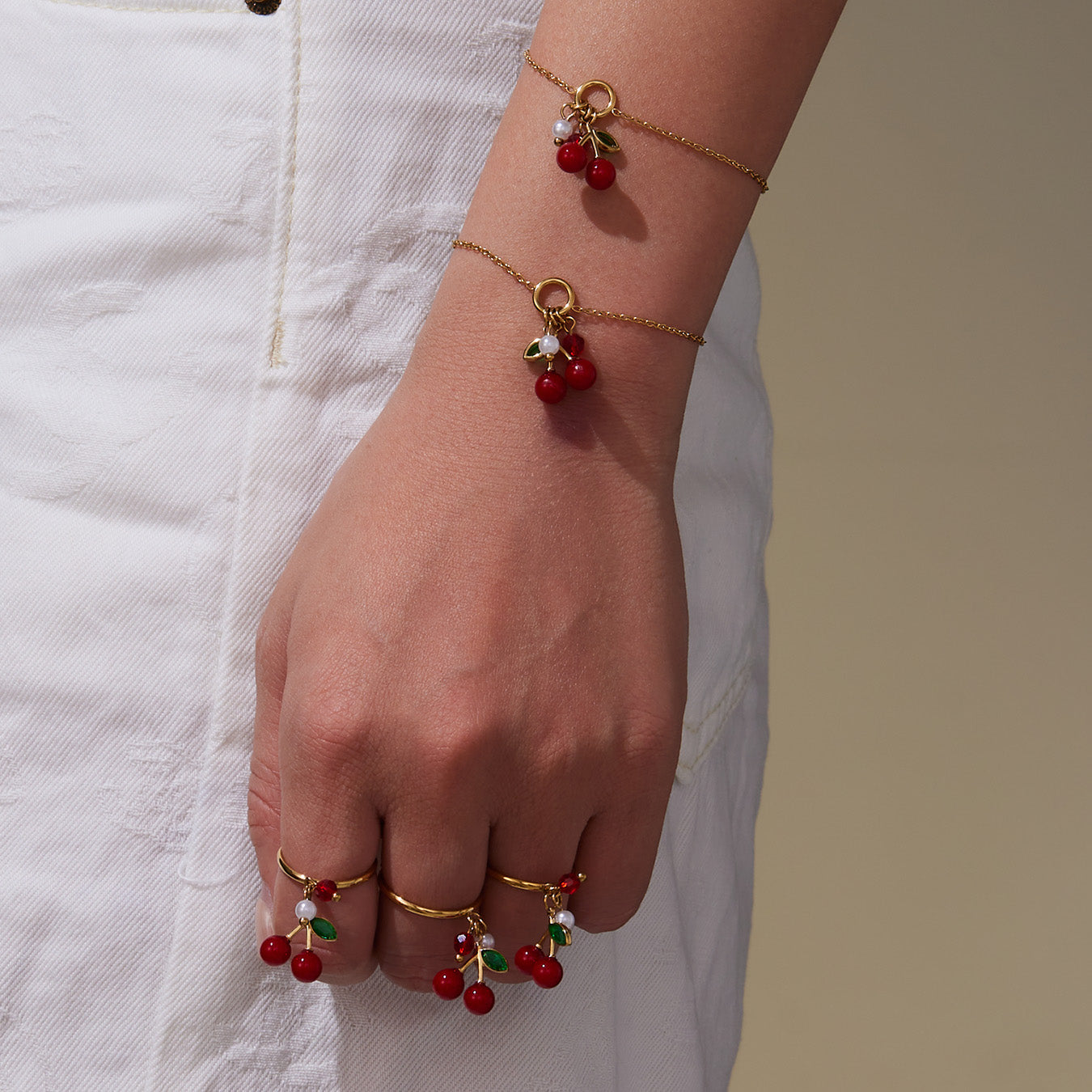 18k gold plated enamel red cherry bracelet and ring on wrist: stack wear
