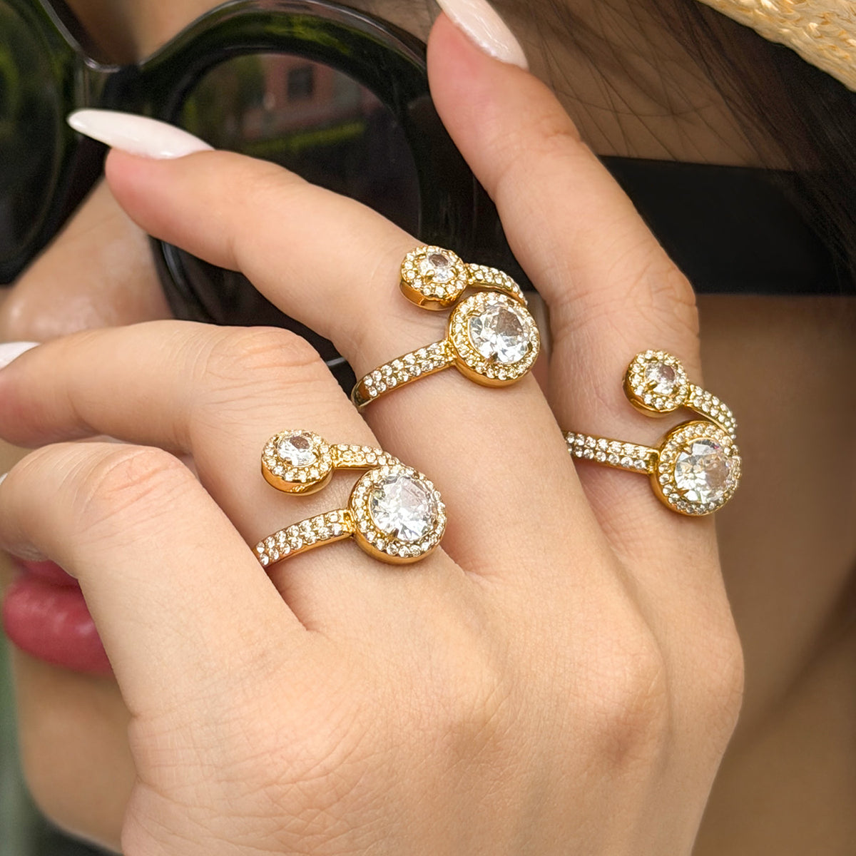 Gold-tone stainless steel double halo rings styled across both hands, with round clear stones and sparkling bands