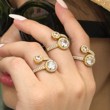 Gold-tone stainless steel double halo rings styled across both hands, with round clear stones and sparkling bands