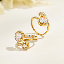 Two gold-tone stainless steel double halo rings displayed upright and tilted to show the stones and band details