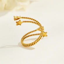 Side and back view of a gold-tone stainless steel twisted open ring, showing star accents and raised stone settings