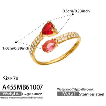 A455 gold-tone stainless steel ring size guide showing a red heart stone, pink-toned oval stone and size 7