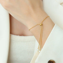 Adjustable 18K PVD gold pearl slider bracelet worn on wrist