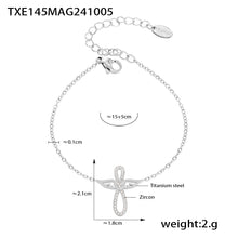 Silver tone angel wing CZ charm bracelet in stainless steel, 15+5cm extender, minimalist luxury style.