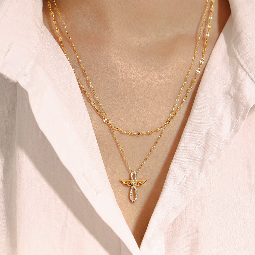 Gold PVD angel wing CZ pendant necklace layered look, stainless steel tarnish-resistant jewelry.