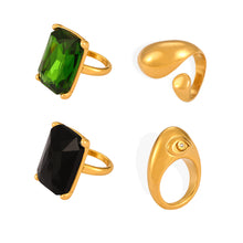 Green and black rectangular stone rings shown alongside two gold-tone sculptural ring designs