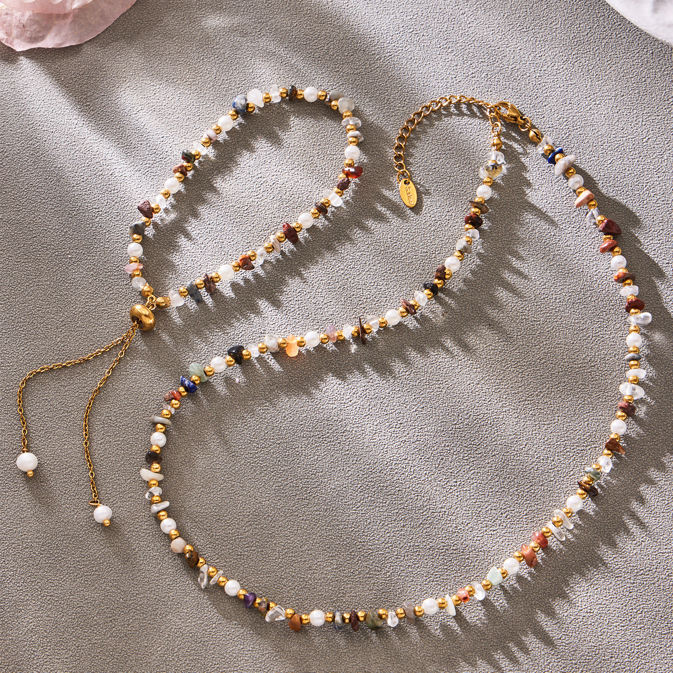 Detailed flat lay of coordinating natural stone necklace and bracelet designs
