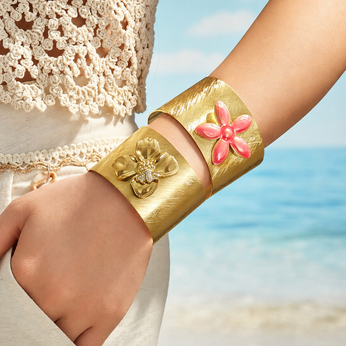 Bee and pink flower wide cuff bracelets styled together on a model wrist