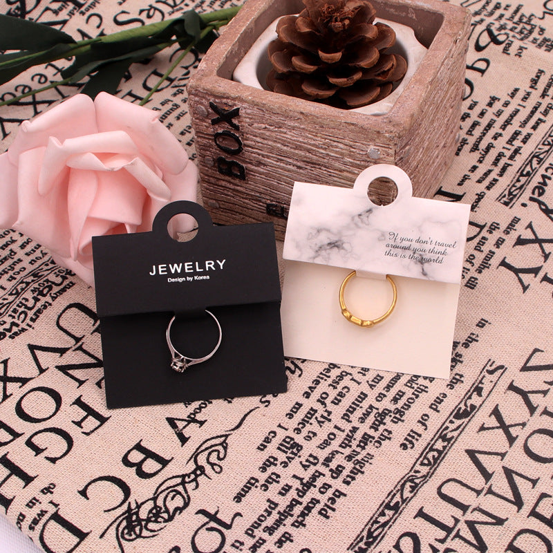 Black and white ring display cards styled with rings for boutique jewelry packaging