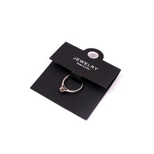 Black ring display card with a ring mounted for jewelry packaging and retail presentation