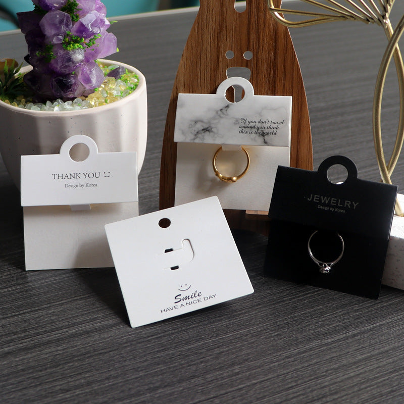Black and white ring display cards used for retail jewelry presentation