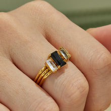 Black cubic zirconia multi-band statement ring with 18K PVD gold finish worn on hand