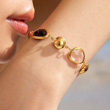 Black glass stone bracelet worn on wrist