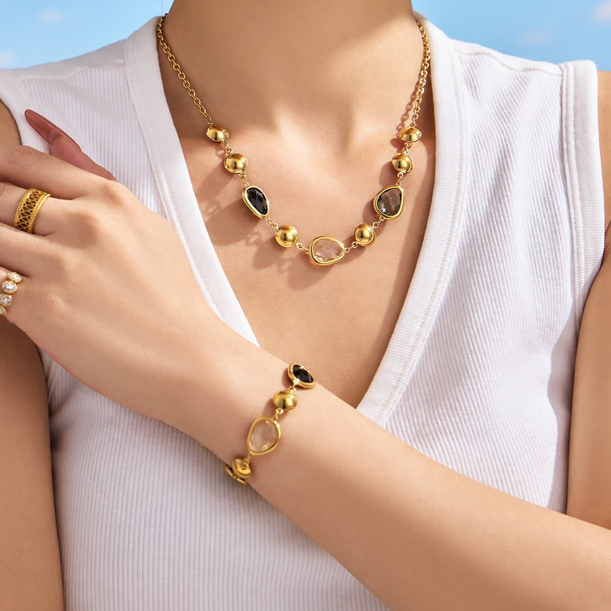 Black glass stone necklace and bracelet worn on model