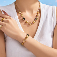 Black glass stone necklace and bracelet worn on model
