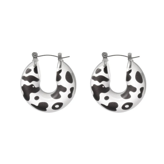 Black and white leopard print resin hoop earrings with 316L stainless steel posts on a white background